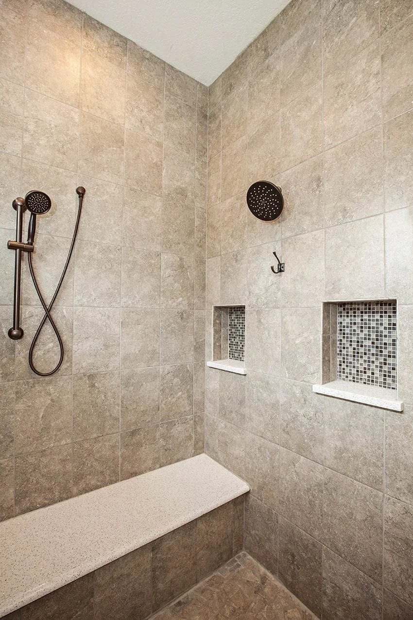 Walk-in shower with large-format tile, a built-in bench and a tiled niche