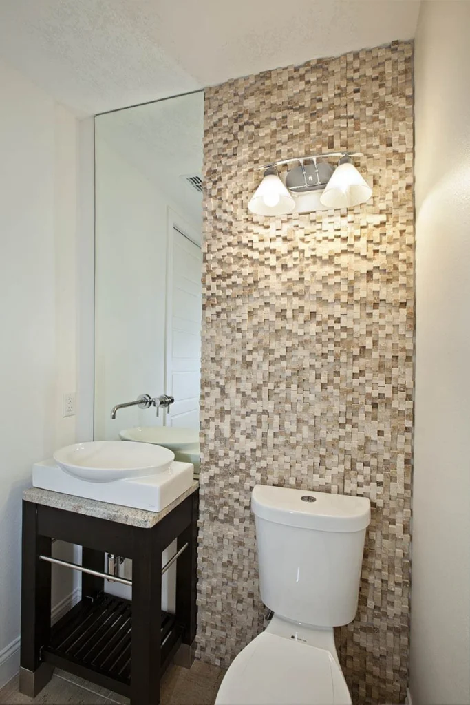 Powder bathroom with a vessel sink and a floor-to-ceiling mosaic tile wall